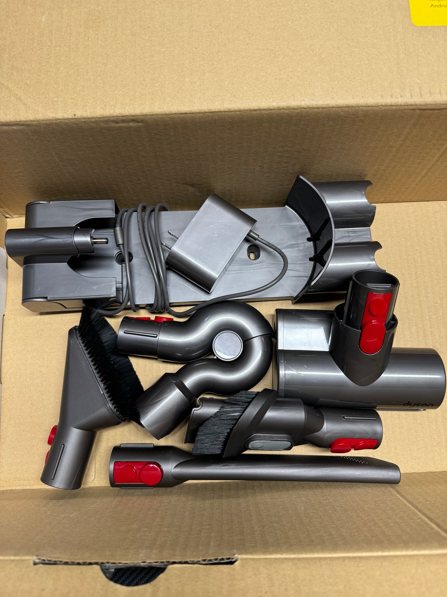 Set of vacuum cleaner attachments on a cardboard box