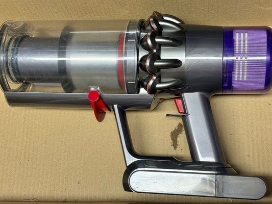 Dyson vacuum cleaner on a cardboard surface
