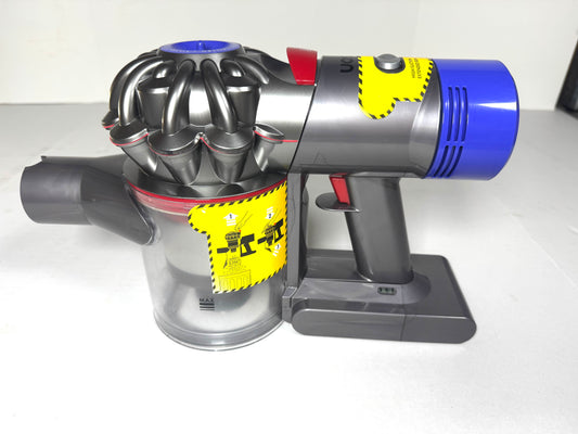 Dyson vacuum cleaner with a yellow warning label on a white background